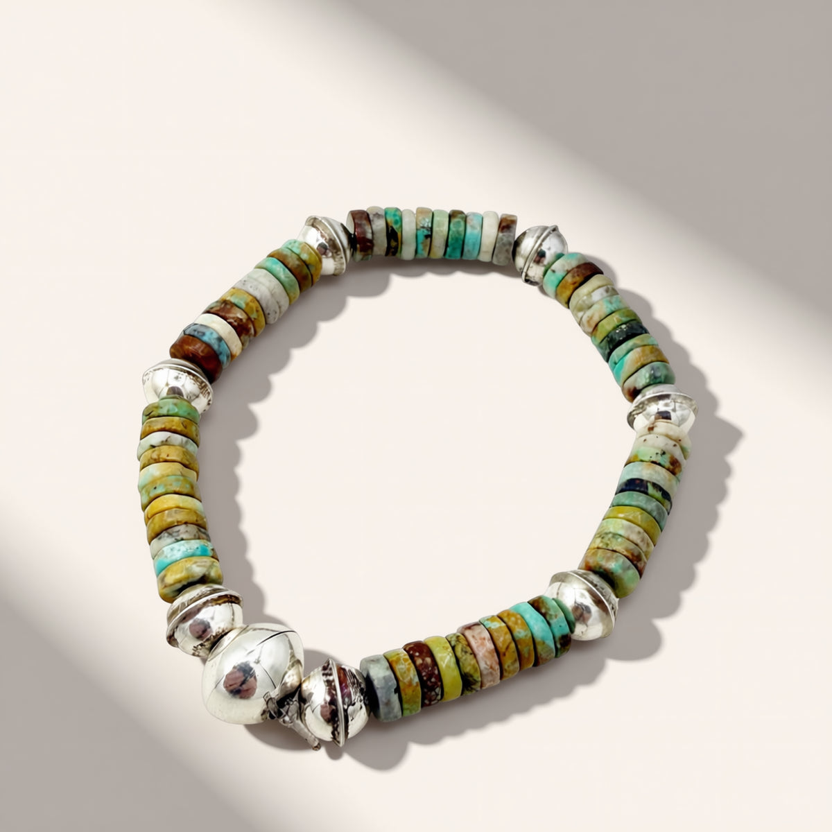 Multicolored beaded bracelet on a light gray background