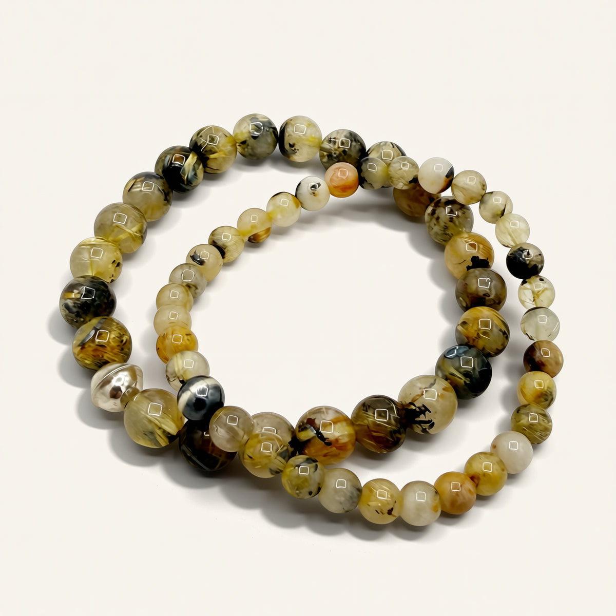 Round beaded bracelet with multicolor stones on a white background