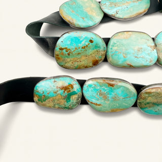 Turquoise stone belt with a black strap on a white background