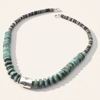 Necklace with turquoise and black beads on a white background