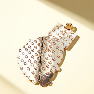 Silver stamp pendant on a beige background