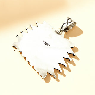 Silver pendant stamp on a beige background