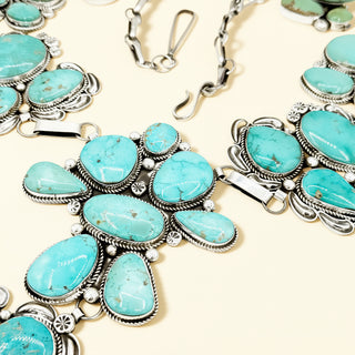 Turquoise jewelry with silver accents on a beige background