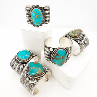 Set of silver rings with turquoise stones on a white background