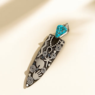 Jewelry pendant with turquoise stone on a beige background