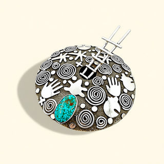 Decorative bowl with abstract patterns and a central turquoise stone on a beige background