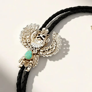 black and silver bolo tie on a beige background