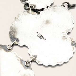 silver jewelry and  'A Cadman' branding on a light background