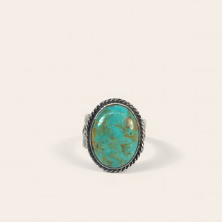 Turquoise ring with silver band on a white background