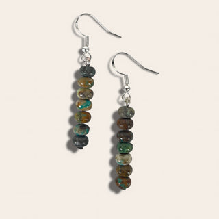 Pair of beaded earrings on a light gray background