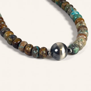 Beaded necklace with natural stone beads on a white background