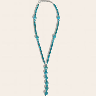 Turquoise beaded necklace on a light gray background