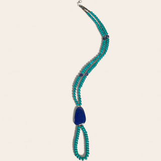 Necklace with blue pendant on a white background