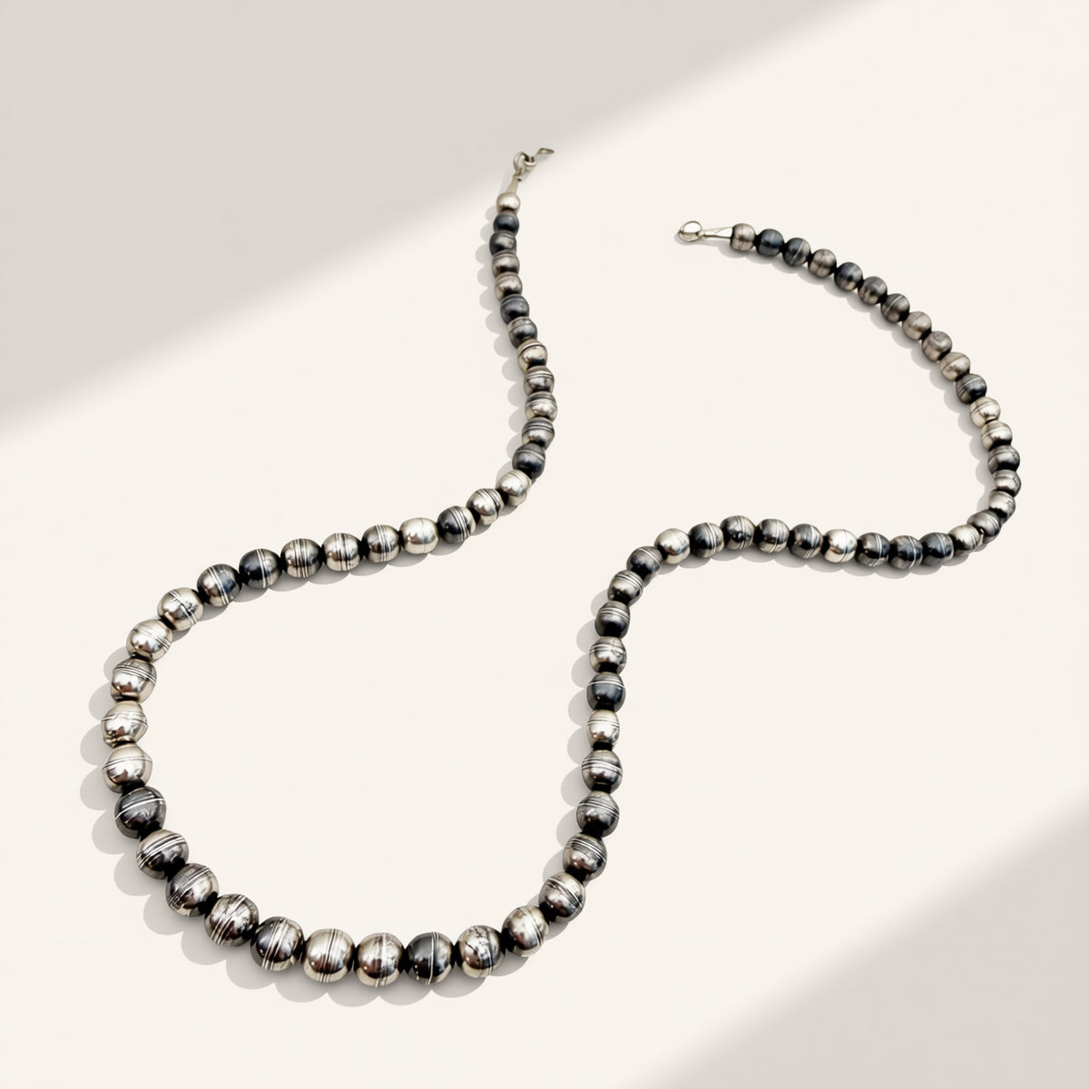 Black and silver beaded necklace on a white background