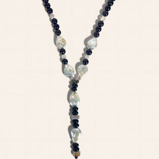 Necklace with black and white beads on a light background