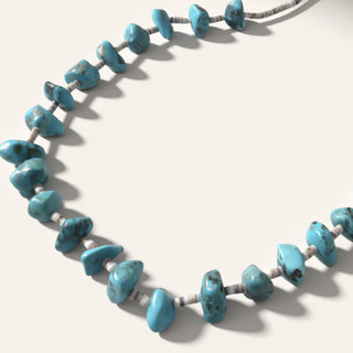 Necklace with blue beads on a white background