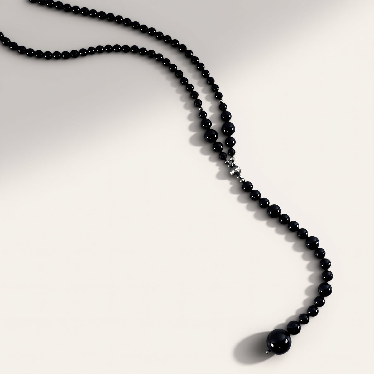 Black beaded necklace on a white background