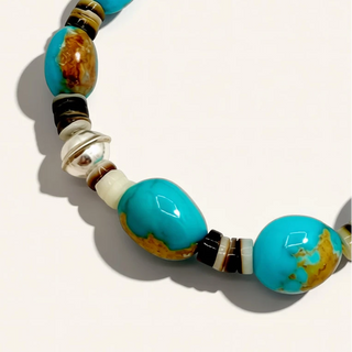Turquoise beaded bracelet on a light beige background
