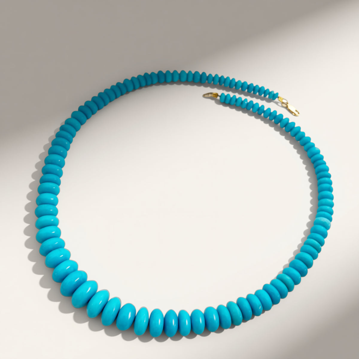 Turquoise beaded necklace on a light gray background