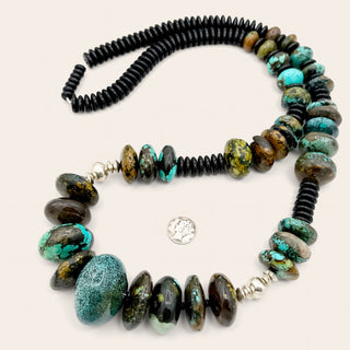 Necklace with turquoise and brown beads on a white background