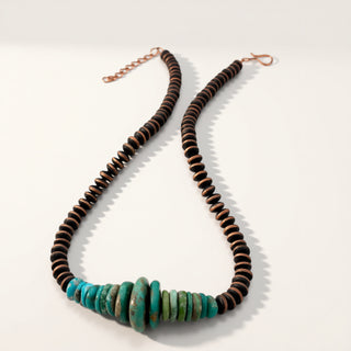 Necklace with brown and turquoise beads on a white background