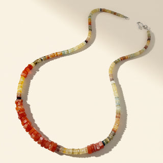 Colorful beaded necklace on a beige background