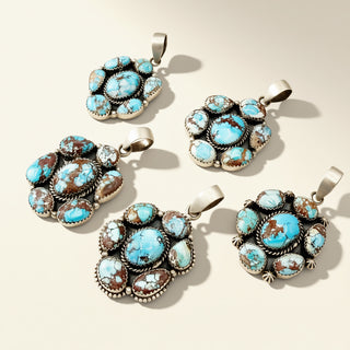 Five turquoise stone pendants on a beige background