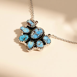 Turquoise flower pendant on a beige background