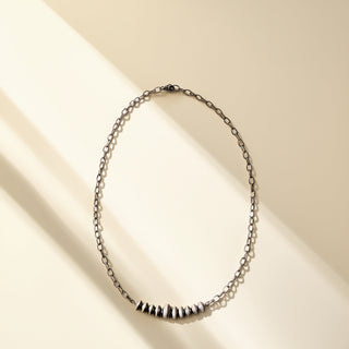 Necklace with black Navajo pearls on a beige background