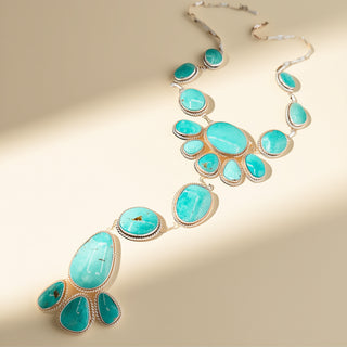 Turquoise stone necklace on a beige background