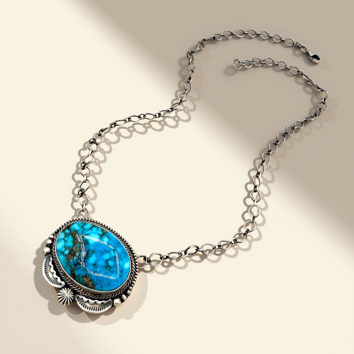 Necklace with a turquoise pendant on a beige background