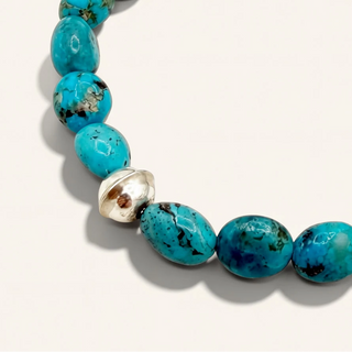 Turquoise beaded bracelet on a white background