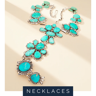 Turquoise necklace with silver accents on a beige background