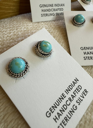 Turquoise earrings on a card with 'Genuine Indian Handcrafted Sterling Silver' text.