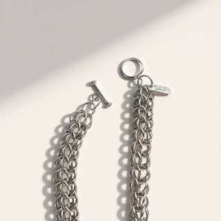 Silver chain bracelet on a light gray background