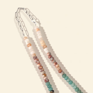 Beaded lanyard with metal clip on a beige background