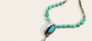 Turquoise beaded necklace with a decorative clasp on a light background
