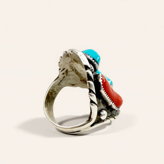 silver ring with red and blue stones on a beige background