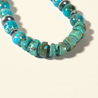 Turquoise beaded necklace on a beige background