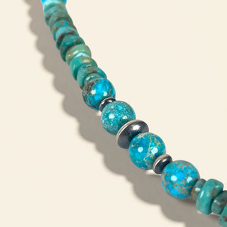 Turquoise beaded necklace on a beige background
