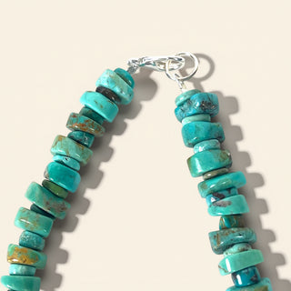 Turquoise beaded bracelet on a beige background