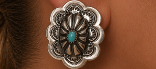 Silver earring on ear 