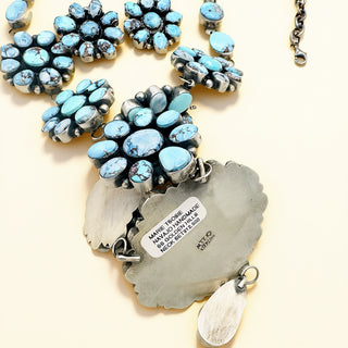 Silver necklace with turquoise stones on a white background