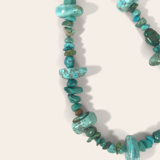 Necklace made of turquoise stone beads on a white background