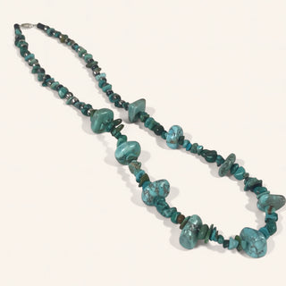 Turquoise beaded necklace on a white background