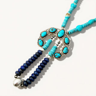 Necklace with turquoise and blue beads on a white background
