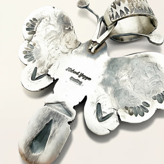 Silver jewelry with intricate designs on a light background