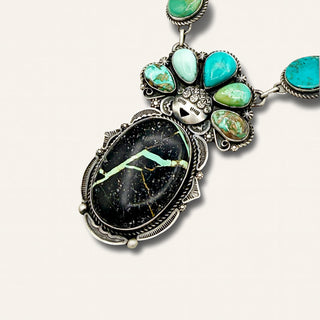 Necklace with large central stone and turquoise stones on a white background