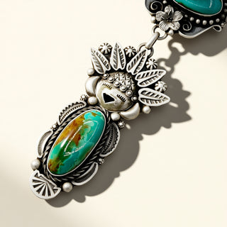 Silver and turquoise pendant on a beige background