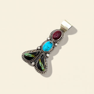 Multicolored stone pendant on a beige background